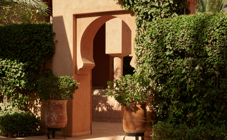 Garden Maison entrance at Amanjena with terracotta archway and climbing vines.