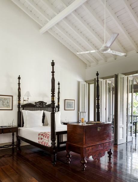 Principal bedroom at Amangalla with four-poster bed and ceiling fan.