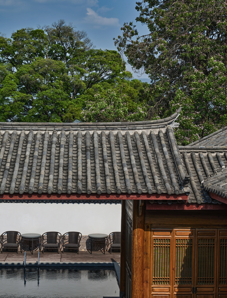 Outdoor swimming pool at Amandayan surrounded by lush greenery in China.