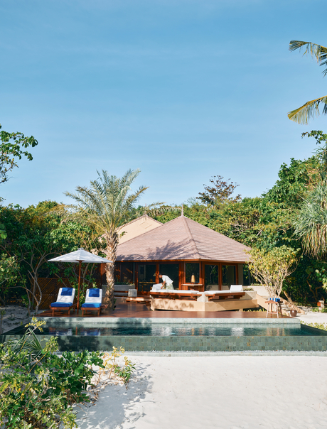 Beach Pool Casita at Amanpulo with thatched-roof pavilion overlooking infinity pool and tropical gardens.