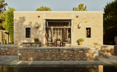 Deluxe sea view pavilion exterior at Amanruya, Turkey, with cream-coloured stone walls and wooden shutters.