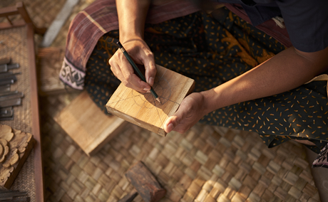 Instructor demonstrating wood carving techniques at Amandari, Indonesia.