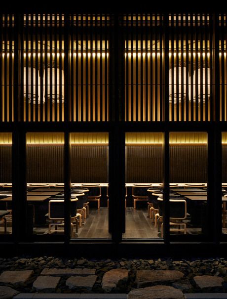 Taka-An exterior at dusk, illuminated wooden lattice doors and warm interior lighting, Aman Kyoto.
