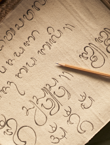 A student writes Aksara Bali script during a calligraphy class at Amandari, Indonesia.