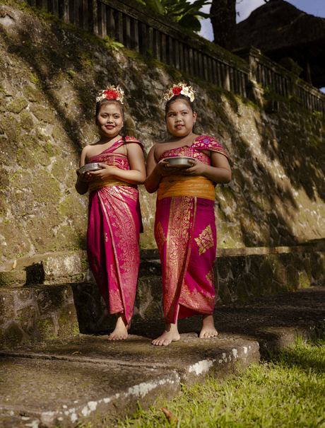 Two young dancers in traditional pink silk costumes at Amandari, Indonesia.