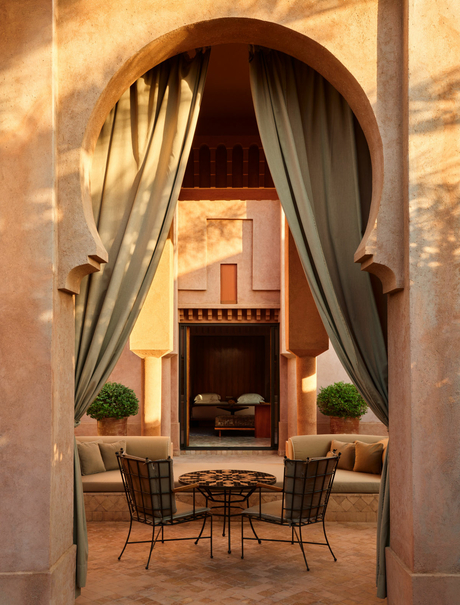 Al Hamra Suite sitting area at Amanjena with arched doorway and draped curtains.