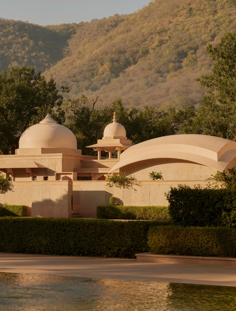 Pool pavilion at Amanbagh overlooking the water and domed architecture beyond.