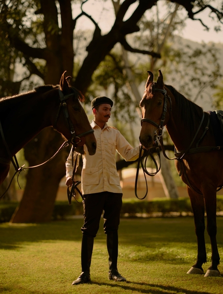 Two people stand beneath an ancient tree at Amanbagh, India, sharing a moment together.