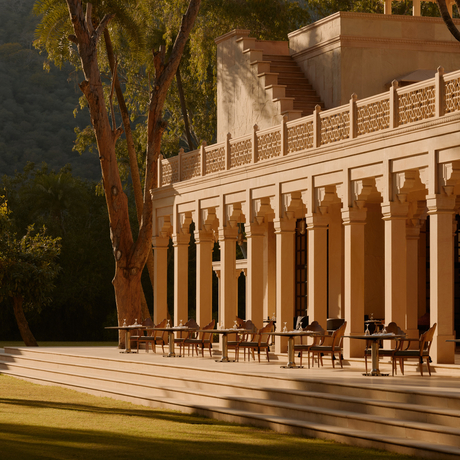 Amanbagh restaurant terrace with columned architecture and dining seating overlooking grounds at dusk.