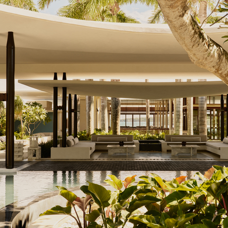 Entrance at Amanera resort, Dominican Republic, with modern pavilion, planted gardens and ambient lighting.