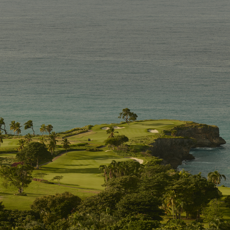 Aerial view of a verdant peninsula at Amanera, Dominican Republic, with manicured grounds meeting turquoise waters.