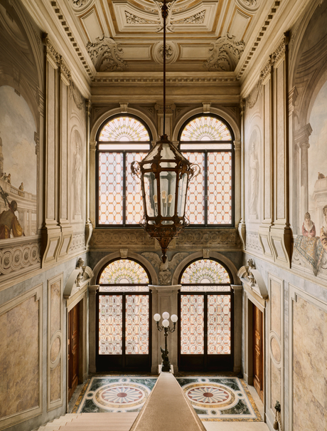 Stone staircase with arched windows at Aman Venice, Italy.