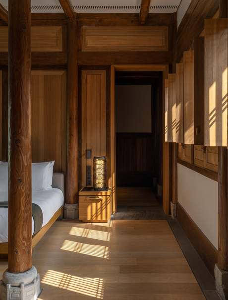 Wooden corridor at Amanyangyun with traditional architectural details and natural light streaming through windows.