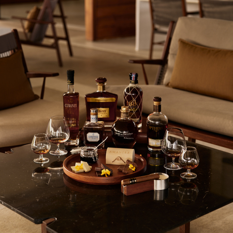 Rum and chocolate tasting display at Amanera resort, featuring bottles and glasses arranged on a wooden board.