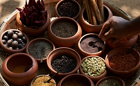 Overhead view of clay bowls filled with spices and ingredients for a cooking lesson at Amanwella, Sri Lanka.