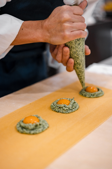 Hand presenting freshly prepared sushi at Aman Tokyo, Japan.