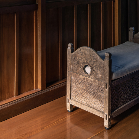 Carved stone architectural detail beside bed in Duplex Suite at Amandari, Ubud, Bali.