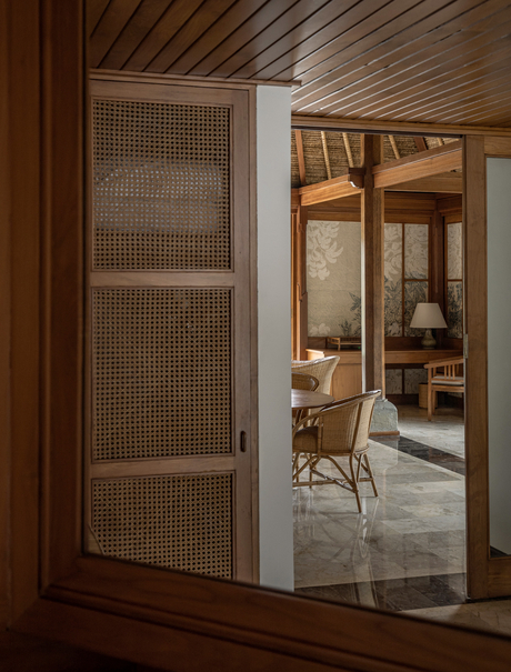 Village Suite at Amandari with wooden sliding door opening to bedroom and en-suite bathroom in Ubud, Bali.