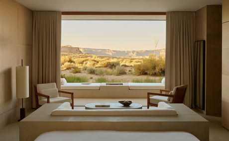 Desert pool suite at Amangiri with panoramic views of the arid landscape beyond the window.