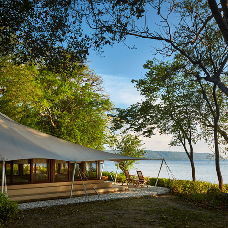 Ocean tent at Amanwana overlooking the sea through trees, Sumbawa, Indonesia.