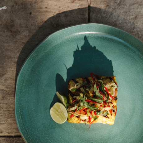 Grilled seafood fillet with lime and vegetables on a turquoise plate at Amanwana, Sumbawa, Indonesia.