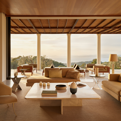 Villa lounge with wooden beams and panoramic views at Amanzoe resort, Greece.