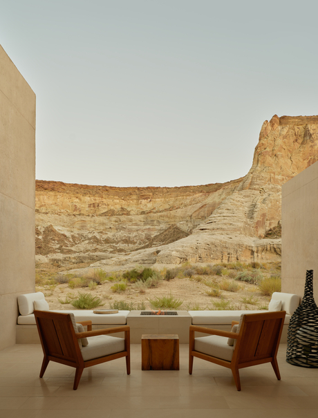Girijaala Suite at Amangiri with two leather chairs facing expansive desert canyon views through floor-to-ceiling windows.