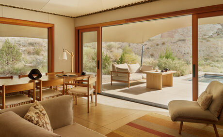 Camp Sarika accommodation pavilion at Amangiri with floor-to-ceiling windows overlooking desert landscape.