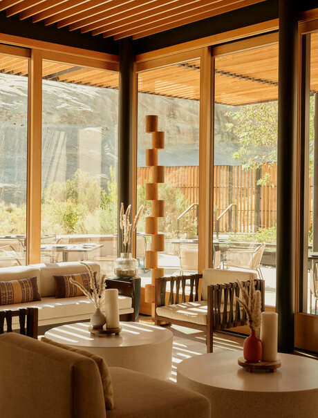 Camp Sarika restaurant at Amangiri with floor-to-ceiling windows overlooking desert landscape.
