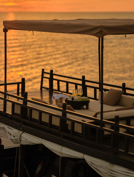 Wooden boat deck at sunset on the Tonlé Sap Lake, Amansara, Cambodia.