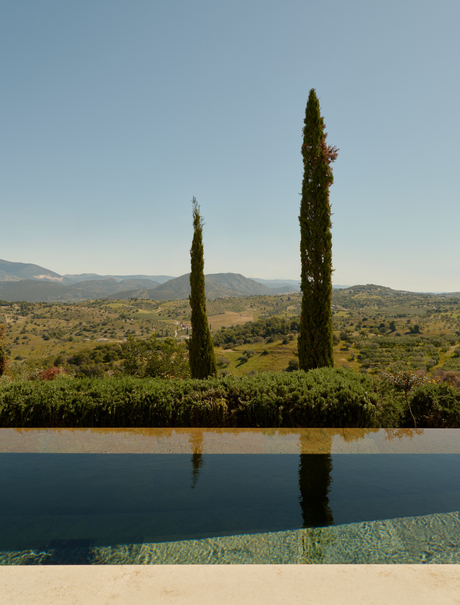 Pool pavilion overlooking cypress trees and Peloponnese landscape at Amanzoe resort.