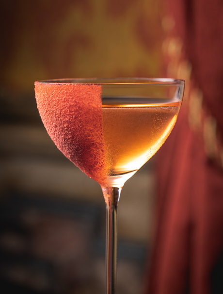 Close-up of Devozione, Aman Venice's signature cocktail, in a coupe glass garnished with grapefruit.