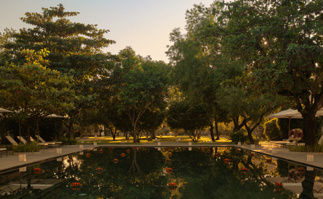 Candlelit lanterns float on a garden pool during Loy Krathong ceremony at Amantaka, Laos.