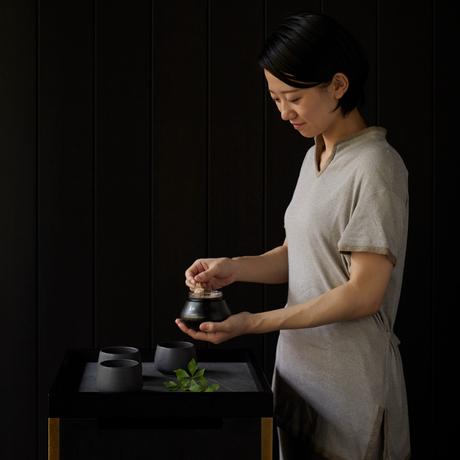 Therapist preparing a wellness treatment at Aman Kyoto spa in Japan.