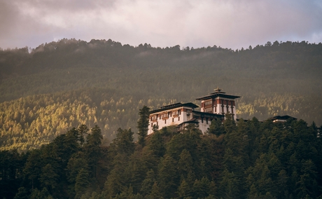 Amankora lodge nestled amongst forested hills in Bumthang Valley, Bhutan.