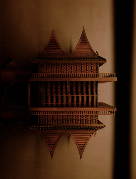 Architectural detail of a traditional Thai-style building at Aman Nai Lert Bangkok, reflected in still water.