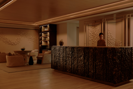Aman Nai Lert Bangkok spa reception desk with warm wooden finishes and carved details.