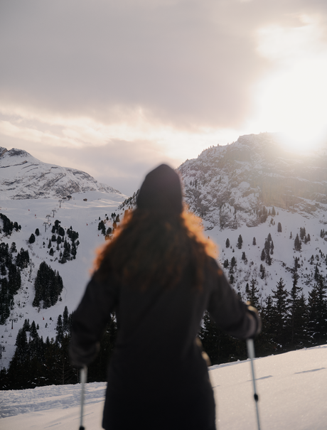 Person snowshoeing in snowy mountains at Aman Le Mélézin, France.
