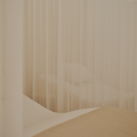 Spa and wellness area at Aman Le Mélézin with soft, draped fabrics and warm neutral tones.