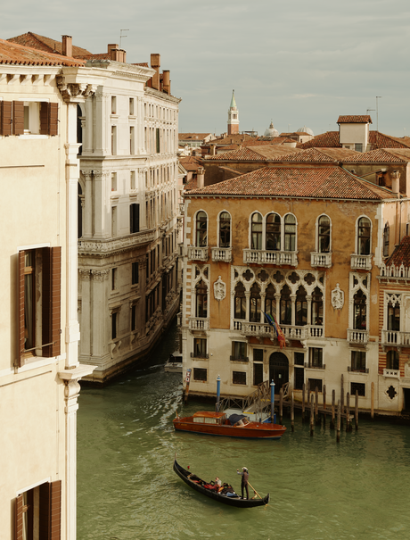 Venetian palazzo view across the Grand Canal at Aman Venice, with traditional gondola and historic buildings.