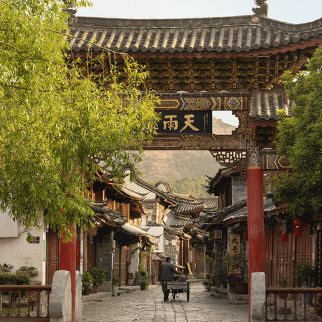 Covered passageway in Lijiang Old Town with traditional Chinese architecture and lantern, Amandayan.