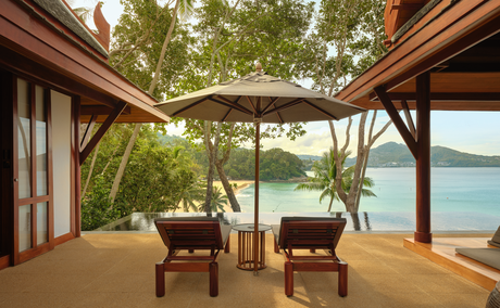 Amanpuri pavilion with open-air seating overlooking tropical gardens and water views, Thailand.