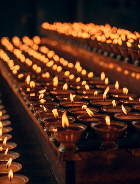 Rows of flickering butter lamps lit during a ceremony at Amankora, Punakha, Bhutan.