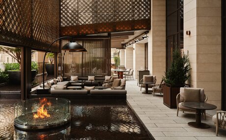 Garden terrace at Aman New York with fireplace and contemporary seating overlooking the city.