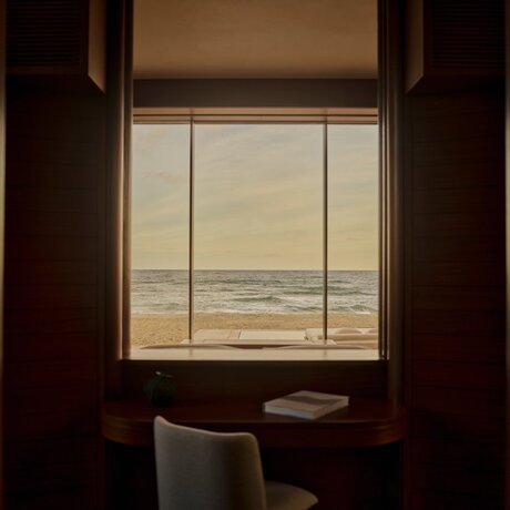 Beachfront casita at Amanvari with ocean view through window and desk seating.
