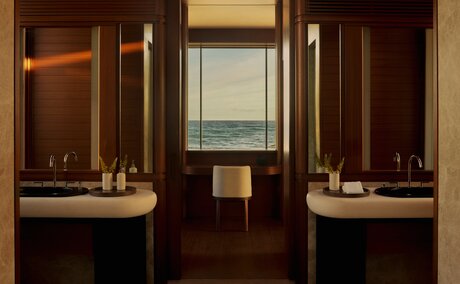 Bathroom with dual vanities and warm wood cabinetry at Amanvari, Mexico.