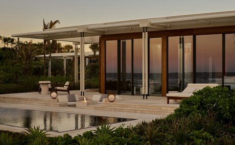 Beachfront casita exterior at dusk with terrace, private pool, and ocean views in Mexico.