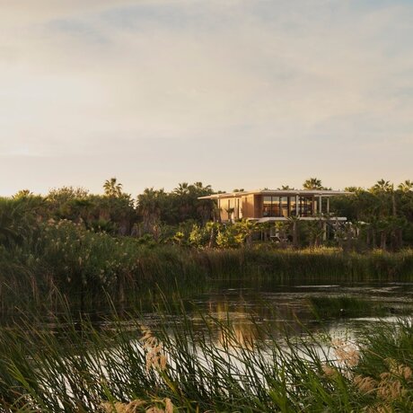 Elevated casita at Amanvari surrounded by lush vegetation and waterfront views in Mexico.