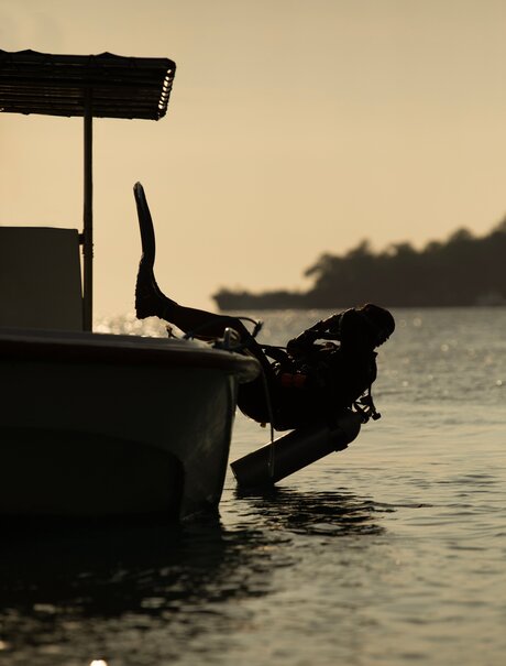 Diver preparing to enter the water from the Aman XVII boat at Amanwana, Indonesia.