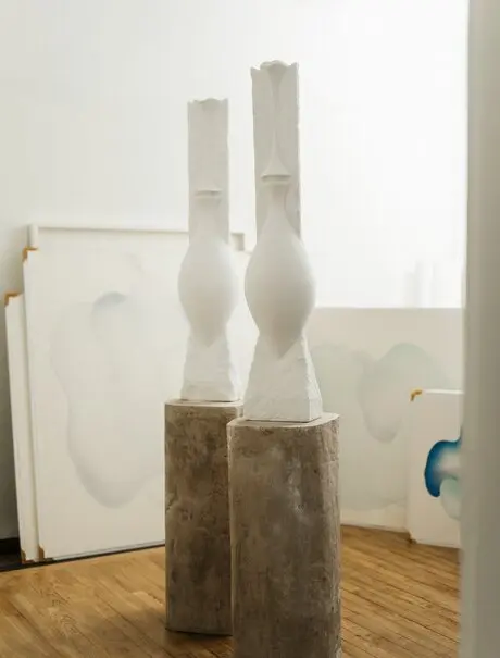 Studio portrait of sculptural white marble forms at Amanzoe art exhibit, Greece.